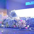 Dreamy Floral Decoration Setup With Blue Pink Flowers And Illuminated Backdrop