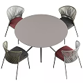 Round Outdoor Table With Metal Legs And Woven Rattan Chairs Red Black Cushions
