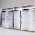 Stainless Steel Commercial Kitchen Appliances Arranged Side by Side in White Tiled Kitchen