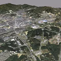 Satellite View of City Surrounded by Green Mountains and River With Residential Industrial Zones