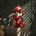 Red Snake Shaped Art Installation With Knitted Hat Scarf And Gold Patterns On Wooden Base