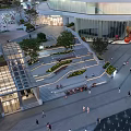 Modern Open Plaza With Steps Greenery And Pedestrians In Urban Area