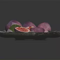 Fresh Figs on Dark Plate Sliced and Whole with Green Leaves Red Flesh Seeds