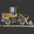 Yellow Small Loader With Front Bucket Placed On Concrete Platform Industrial Machinery