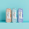 Coarse Grain Treasure Beverage in Three Colorful Cans on Light Blue Background