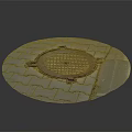 Circular Manhole Cover on Gray Brick Pavement With Grid Design and Small Green Plant