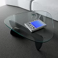 Modern Glass Coffee Table On Gray Carpet With Book And Glass Near Sofa