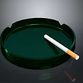 Green Round Glass Ashtray With White Cigarette On Dark Background