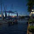 Scenic Evening Marina Landscape With Sailboats Palm Trees And Lit Street Lamps