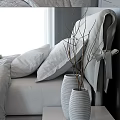 Double Bed With White Bedding Soft Pillows Gray Fabric Bedside Table Vases Fresh Flowers Leaves