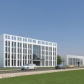 Modern Office Building With Glass Facade Lawn And Adjacent Structure With Cars
