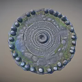 Ancient Circular Stone Labyrinth Structure With Decorative Carvings Grass Patches And Surrounding Stones