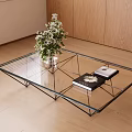 Modern Glass Coffee Table with Metal Frame Flower Vase and Books on Wooden Floor