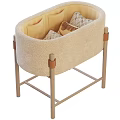 Beige Soft Padded Baby Crib With Sturdy Wooden Legs And Decorative Pillows