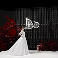Elegant Wedding Stage With White Bridal Gown Red Floral Decor And Hanging Crystals