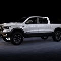 White Ram 1500 Crew Cab Pickup With Off Road Tires And Black Wheels