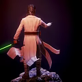 Iconic Star Wars Film Character Luke Skywalker In White Robe Holding Green Lightsaber On Rock