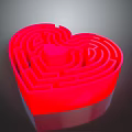 Red Heart Shaped Maze Sculpture With Intricate Carving And Glossy Surface Design