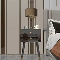 Modern Glossy Black Bedside Table With Table Lamp Photo Frames And Decorative Items In Bedroom