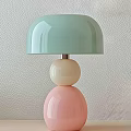 Light Green Shade Chandelier with Cream Colored Sphere and Pink Sphere Against Light Textured Wall