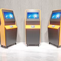 Public Facility Three Yellow And Black Self Service Kiosks With Screen Displays