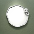 Irregular Shaped Wall Mirror With Yellow Flowers And Bedroom Reflection On Green Wall
