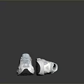 Modern Stylish Sports Shoes With White And Gray Design On Concrete Surface
