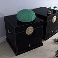 Black Entryway Side Cabinets With Circular Brass Handles Green Knitted Item And Small Potted Plants