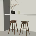 Two Wooden Bar Stools Under White Countertop With Black Vase And White Candles