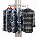 Stylish Plaid And Geometric Pattern Shirts Hanging On Metal Rotating Hanger