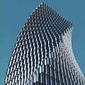 Modern Tall Office Building With Glass Curtain Walls And Unique Curved Structure Against Blue Sky