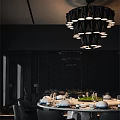 Modern Restaurant Interior Featuring Black Pendant Lights Dark Walls And Dining Table Setup 3d model