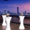 Glowing White High Dining Tables On Rooftop Terrace Overlooking Stunning Modern City Night View