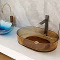 Blue Brown Oval Glass Washbasins On White Countertop With Marble Wall And Metal Faucets