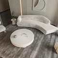 Modern Curved Velvet Sofa With Round White Coffee Table Accent Chair And Gray Rug