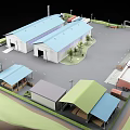 Industrial Factory Complex Featuring Multiple Blue Roof Buildings Parking Area Trucks And Greenery