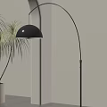 Black Arc Floor Lamp with Dome Shade Near Palm Plant in Light Colored Wall Room