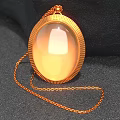 Decorative Jewelry Ornament Set With Gold Oval Shiny Pendant On Black Stone Background