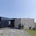 Modern Detached Villa with Stone Walls Black Facade and Stone Patio Entrance Area