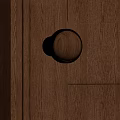 Wooden Door Knob With Brass Rim On Dark Wood Grain Door Panel