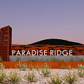 Red Paradise Ridge Feature Wall With Textured Design Surrounding Plants And Green Hills