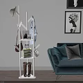 Wooden Tree Shaped Coat Rack With Books Boots And Blue Sofa In Living Room