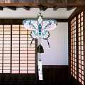 Traditional Japanese Butterfly Wind Chime Pendant With Colorful Floral Patterns Hanging In Wooden Interior