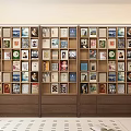 Wooden Bookshelf Filled With Various Colorful Book Spines And Art Prints