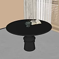 Black Round Dining Table in Modern Interior with Vase Plant and Open Book