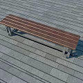 Modern Outdoor Bench With Wooden Slats And Metal Frame On Stone Tile Floor