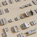 Various Metal Hinges of Different Sizes Laid on Wooden Surface
