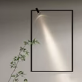 Modern Wall Lamp with Black Frame Illuminating Gray Wall and Bamboo Plant