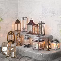 Varied Style Candle Lanterns Decorative Display On Stone Steps With Green Plants