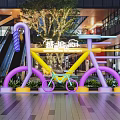 Colorful Bicycle Art Installation Photo Spot In Modern Mall With Vibrant Colors And Green Plants
